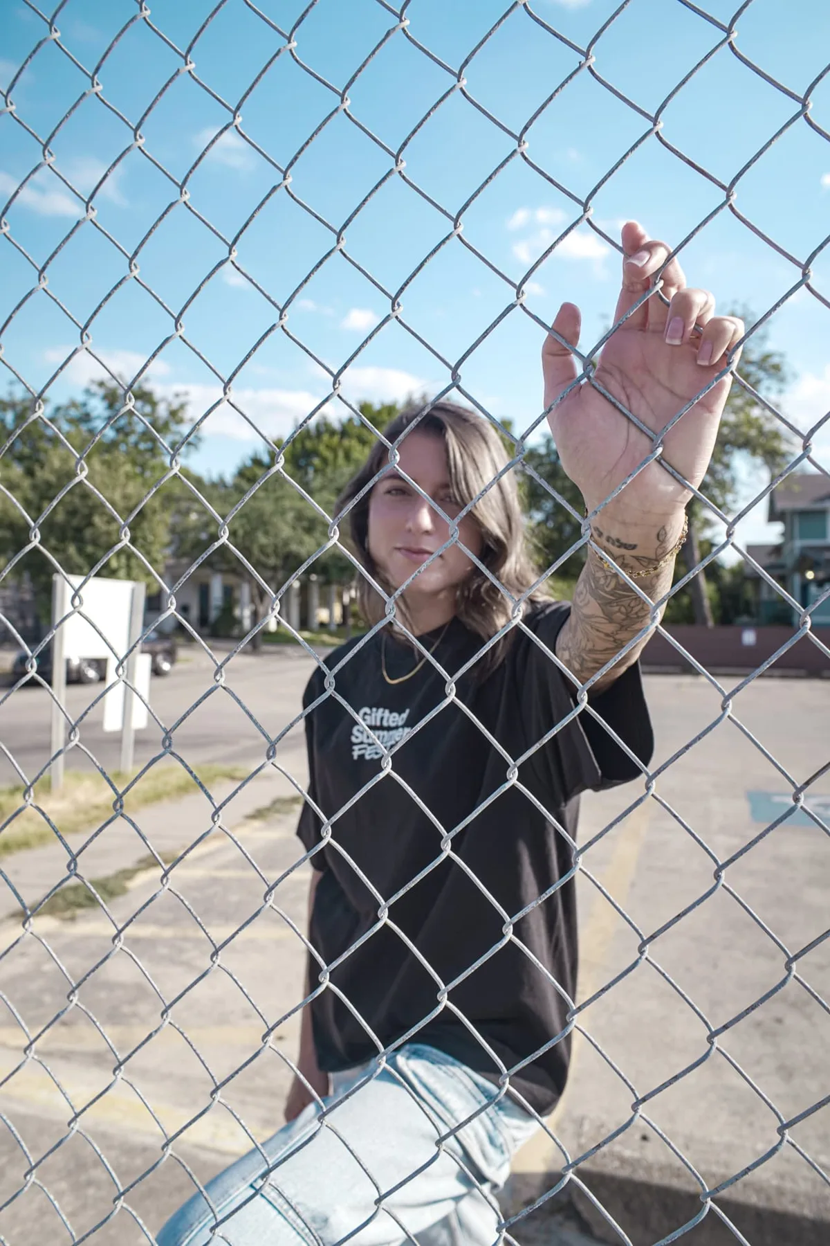 Gifted Summer Fest tee worn beside a chain-link fence